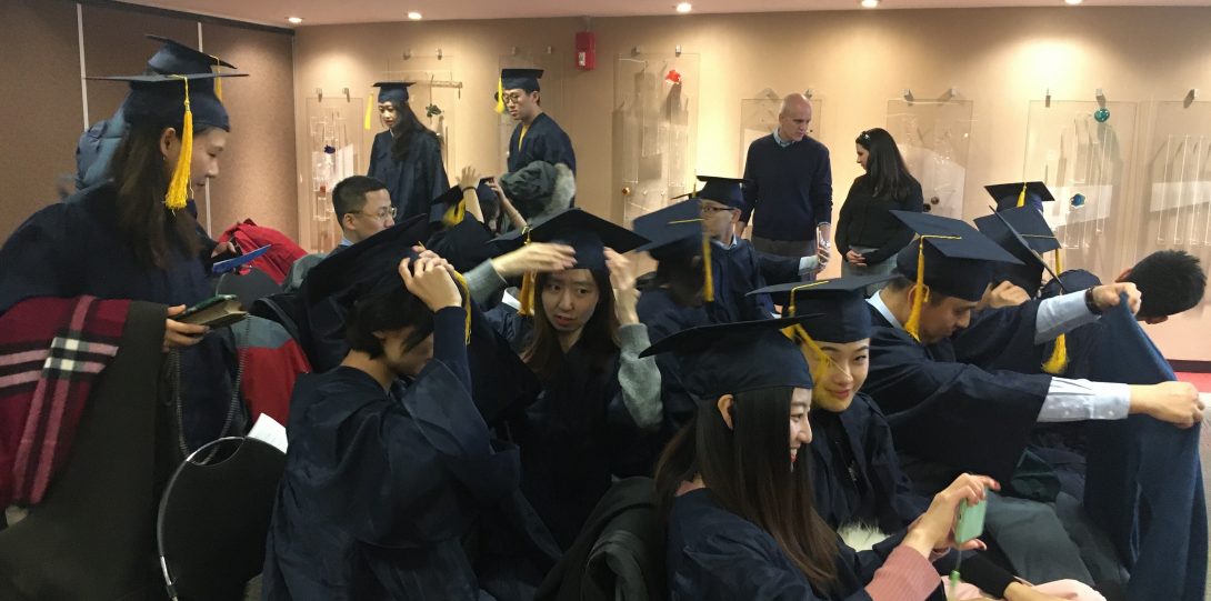 Students in their caps and gowns getting ready to graduate